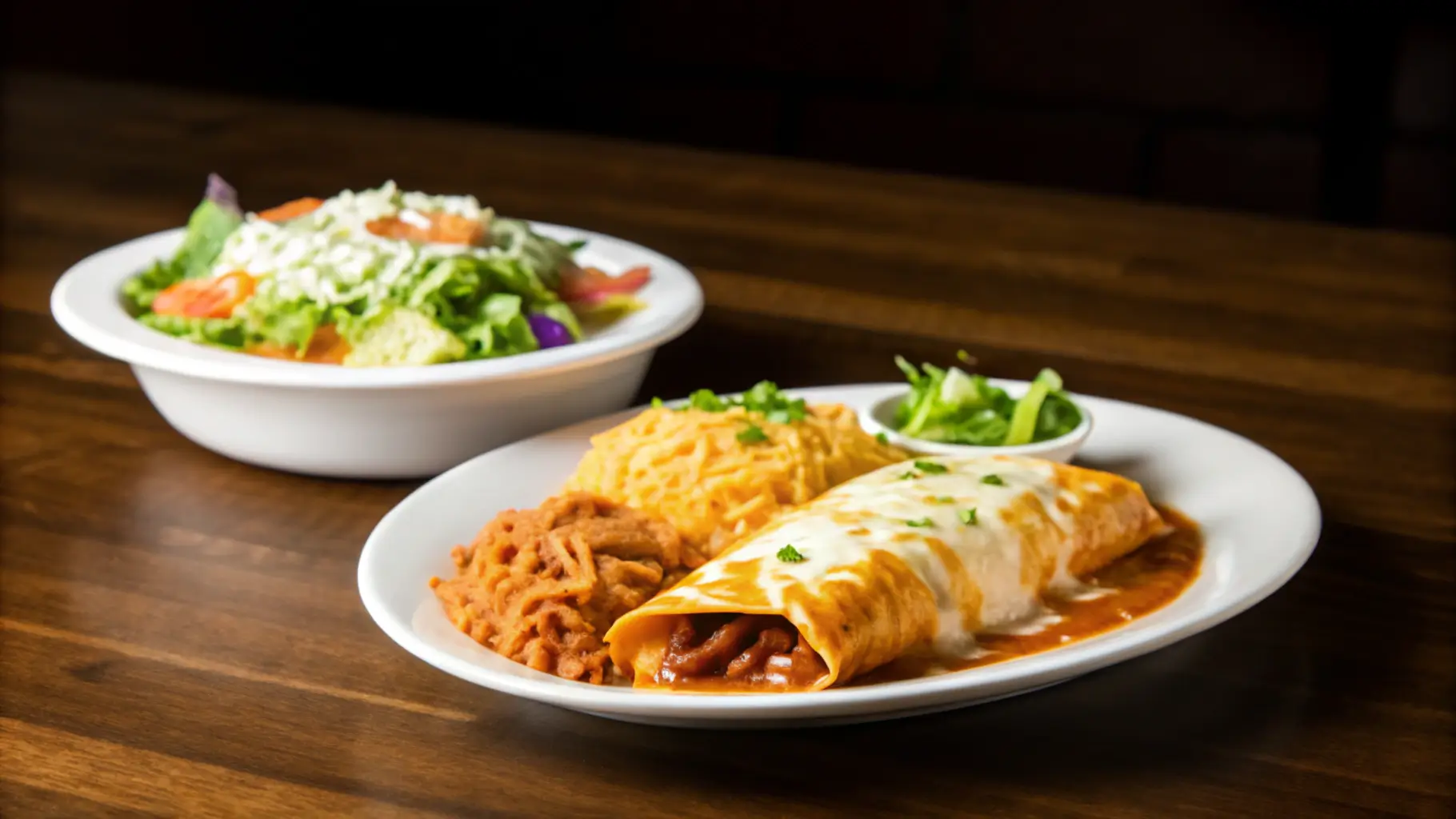 A plate of freshly baked enchiladas with melted cheese, served with rice.